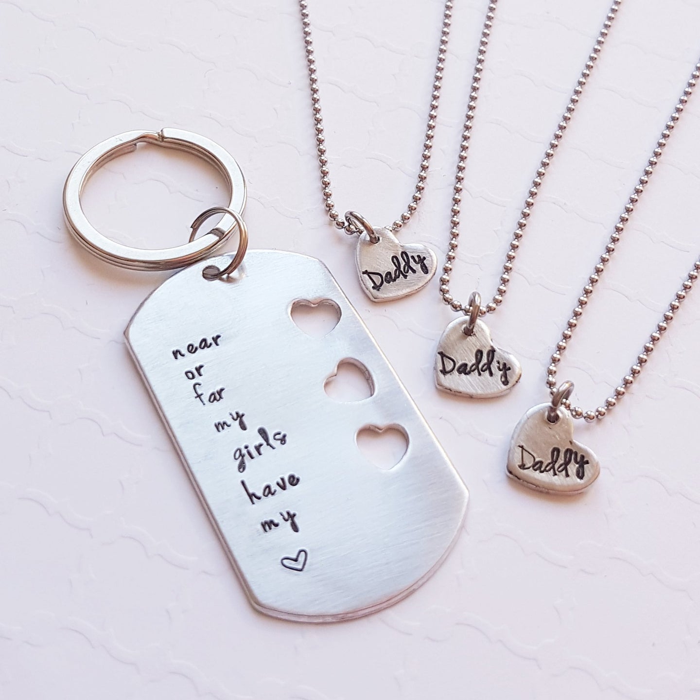 daddy-daughter keychain and necklace set with cut-out hearts for three daughters