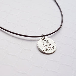 rustic silver disc stamped with "I'm no lady"