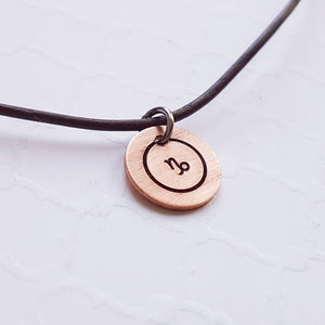 copper zodiac sign disc on leather chain