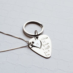 steel guitar pick keychain with heart cut out on a necklace