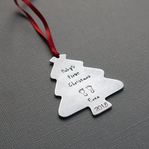 "baby's first christmas" tree-shaped christmas ornament with baby's name, birth year, and tiny footprint stamps
