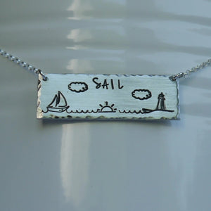 Silver bar necklace with sailboat, sunrise, and lighthouse