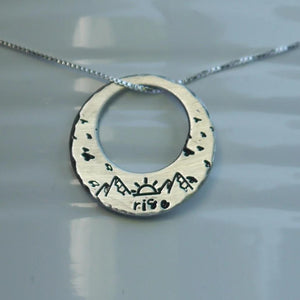 Washer necklace with sunrise, birds, and mountains