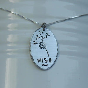 Silver oval pendant with dandelion and "wish"
